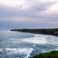 Pemandangan Jalur Lintas Selatan Jawa yang membentang indah di tepi Samudra Hindia, menyuguhkan rute perjalanan darat dengan perpaduan perbukitan hijau dan tebing karang yang mempesona.
