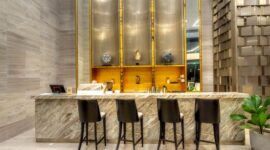 Suasana lobi Hotel Nusantara di Penajam Paser Utara yang memadukan keindahan elemen arsitektur kayu tradisional Dayak dengan fasilitas kemewahan modern. Pemandangan hutan tropis Kalimantan terlihat jelas melalui jendela kaca besar yang memberikan pencahayaan alami sepanjang hari.