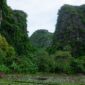 Dua wisatawan menikmati pemandangan lanskap tebing granit hijau dan hamparan sawah di Lembah Harau, Kabupaten Lima Puluh Kota, Sumatera Barat.